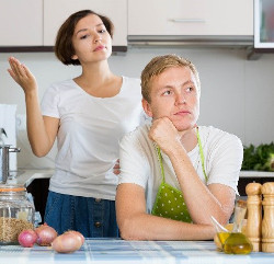 Woman and man in kitchen thinking about dinner